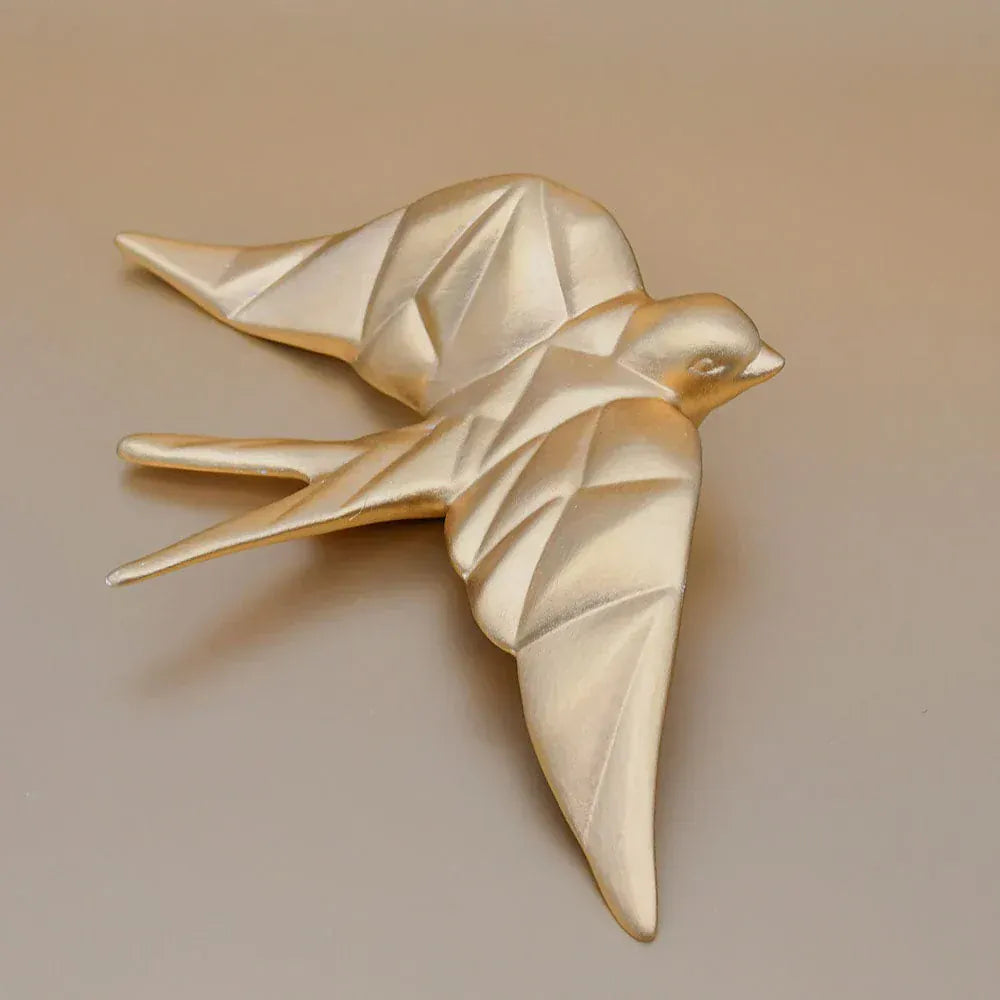 hirondelle en céramique stylisée et modernisée dorée, dans sa boîte cadeau Luisa Paixão.  Coffret hirondelle stylisée - Doré